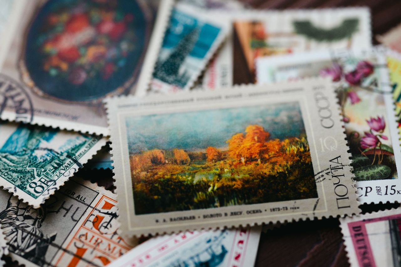 Assorted vintage postage stamps featuring diverse art and designs in a close-up view.